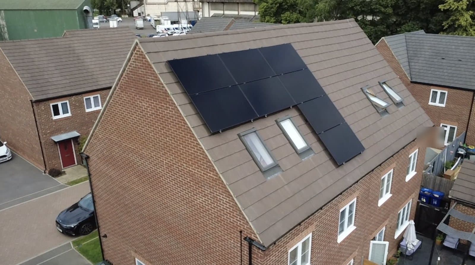 Drone view of an all-black solar array on a family home